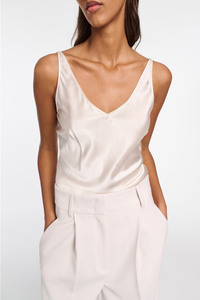 front profile model wearing Sense Of Shine Top Natural White cami silk loose v-neck