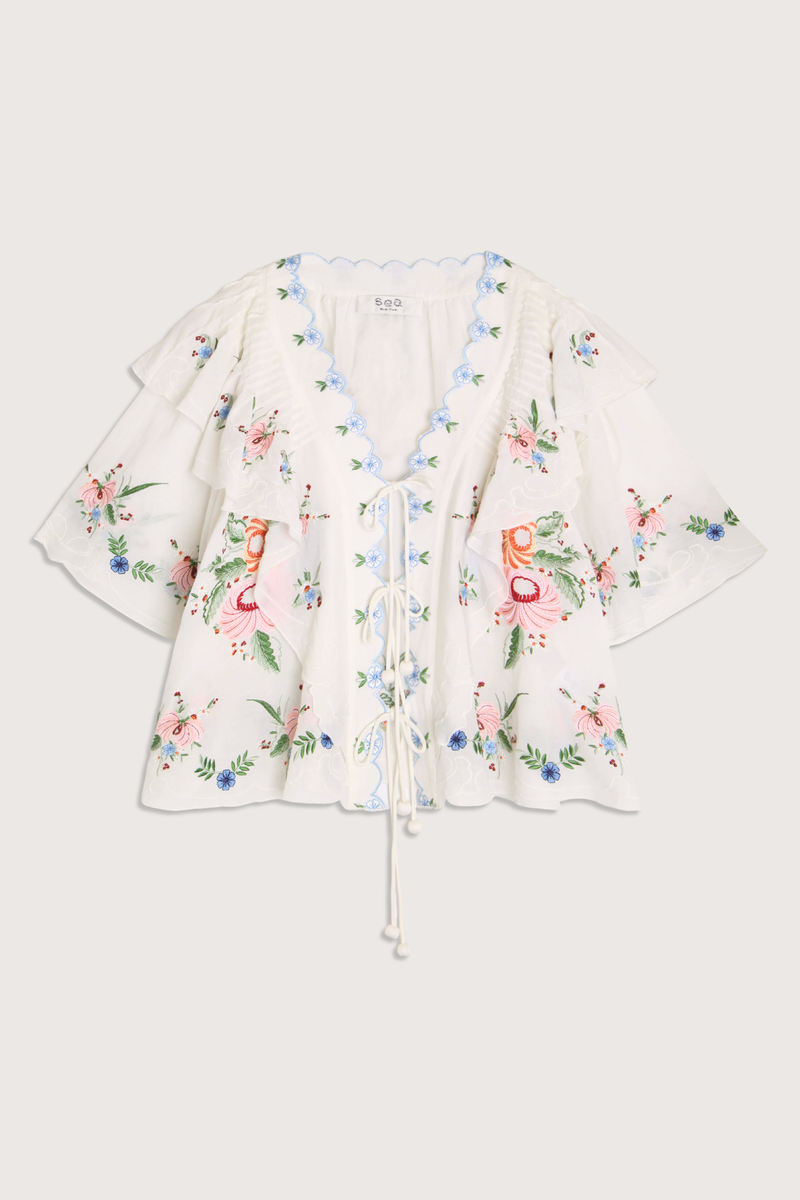 flat lay Serafina Embroidered Front Tie Embroidered short sleeve top
Intricate floral embroidery throughout
Flattering v-neckline
Scalloped edges
Self-tie closures
Tie front closure