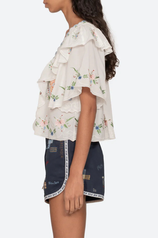 side profile model wearing Serafina Embroidered Front Tie Embroidered short sleeve top
Intricate floral embroidery throughout
Flattering v-neckline
Scalloped edges
Self-tie closures
Tie front closure