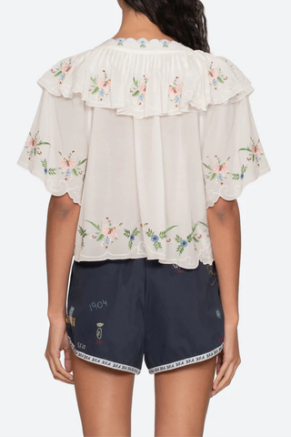 back profile model wearing Serafina Embroidered Front Tie Embroidered short sleeve top
Intricate floral embroidery throughout
Flattering v-neckline
Scalloped edges
Self-tie closures
Tie front closure