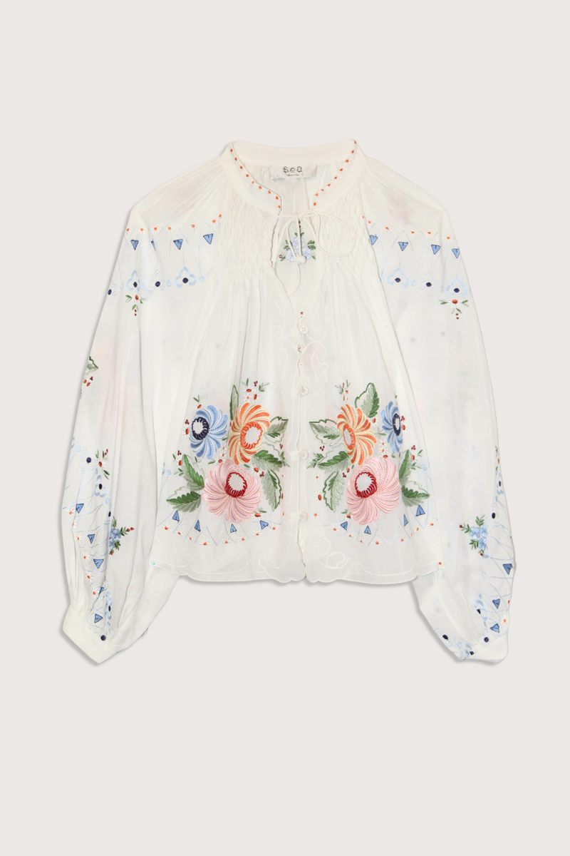 flat lay Serafina Embroidered Long Sleeve Top white multi Long sleeves
Floral embroidery
Flatter v-neckline
Delicate self-tie closure
Tassel accents
viscose cotton blend
Button front