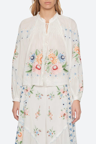 front profile model wearing Serafina Embroidered Long Sleeve Top white multi Long sleeves
Floral embroidery
Flatter v-neckline
Delicate self-tie closure
Tassel accents
viscose cotton blend
Button front
