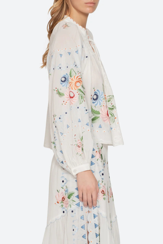 side profile model wearing Serafina Embroidered Long Sleeve Top white multi Long sleeves
Floral embroidery
Flatter v-neckline
Delicate self-tie closure
Tassel accents
viscose cotton blend
Button front