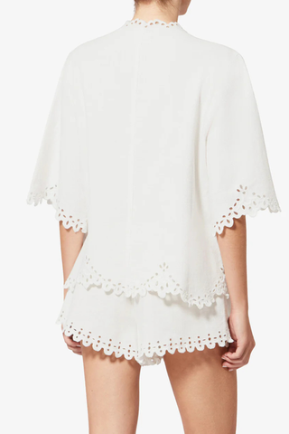 back profile model wearing Shana Top white Tunic style top in soft openwork cotton
Tunisian neckline with broderie anglaise
Short flared sleeves with openwork cuffs
Flared openwork hem
100% cotton