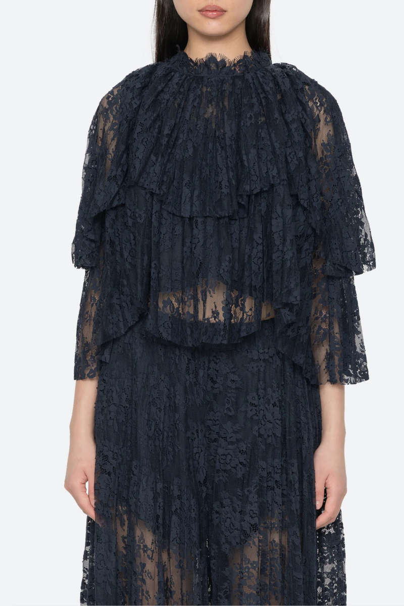 front profile model wearing Sharleen Lace Cape Top navy Cape-style silhouette
Intricate floral lace
Subtle pleated detailing
Slightly cropped length
Asymmetrical hem
self-51% cotton, 49% polyester