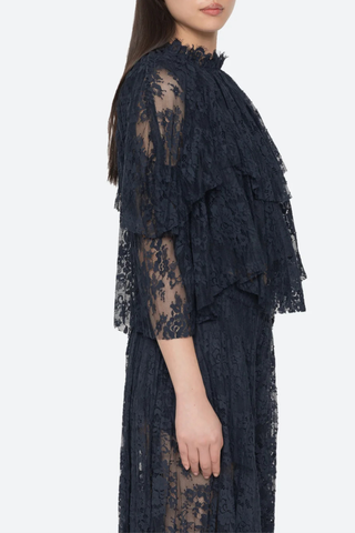 side profile model wearing Sharleen Lace Cape Top navy Cape-style silhouette
Intricate floral lace
Subtle pleated detailing
Slightly cropped length
Asymmetrical hem
self-51% cotton, 49% polyester