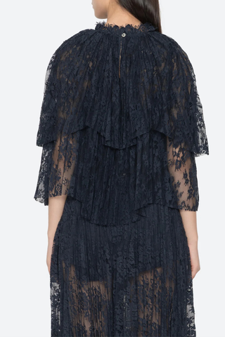 back profile model wearing Sharleen Lace Cape Top navy Cape-style silhouette
Intricate floral lace
Subtle pleated detailing
Slightly cropped length
Asymmetrical hem
self-51% cotton, 49% polyester