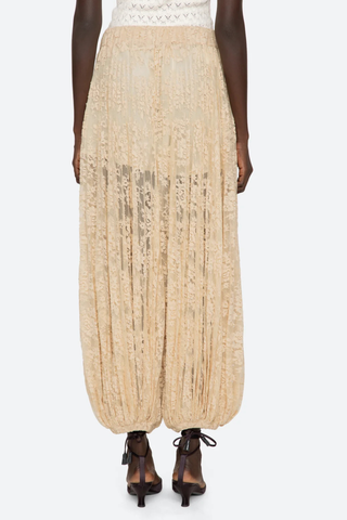 back profile model wearing Sharleen Lace Pant Khaki Voluminous balloon silhouette
Pleated
Comfortable elasticized waistband
Sheer floral lace
Self-51% cotton, 49% polyester
Slip on