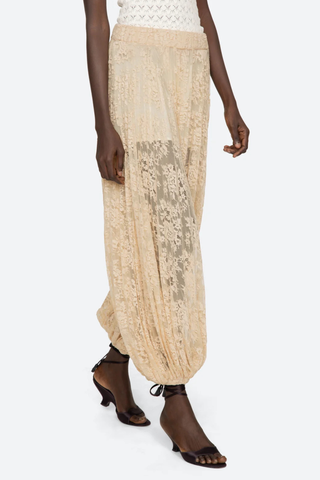 angled walking profile model wearing Sharleen Lace Pant Khaki Voluminous balloon silhouette
Pleated
Comfortable elasticized waistband
Sheer floral lace
Self-51% cotton, 49% polyester
Slip on