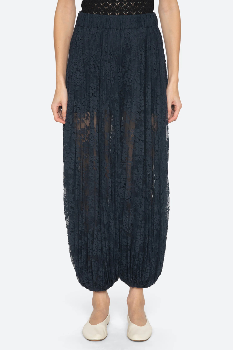 front profile model wearing Sharleen Lace Pant Navy Voluminous balloon silhouette
Pleated elasticized waistband
Sheer floral lace
Self-51% cotton, 49% polyester
Slip on

Elasticized waist