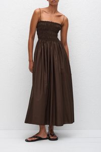 front profile model wearing Shirred Bodice Midi Dress chocolate brown Pull-on dress
Cami style
Delicate shoulder straps
Repeated double elastic shirred detailing throughout the bodice
Mid-length style
Self-lined bodice
Side pockets
100% Organic Cotton Cami Dress