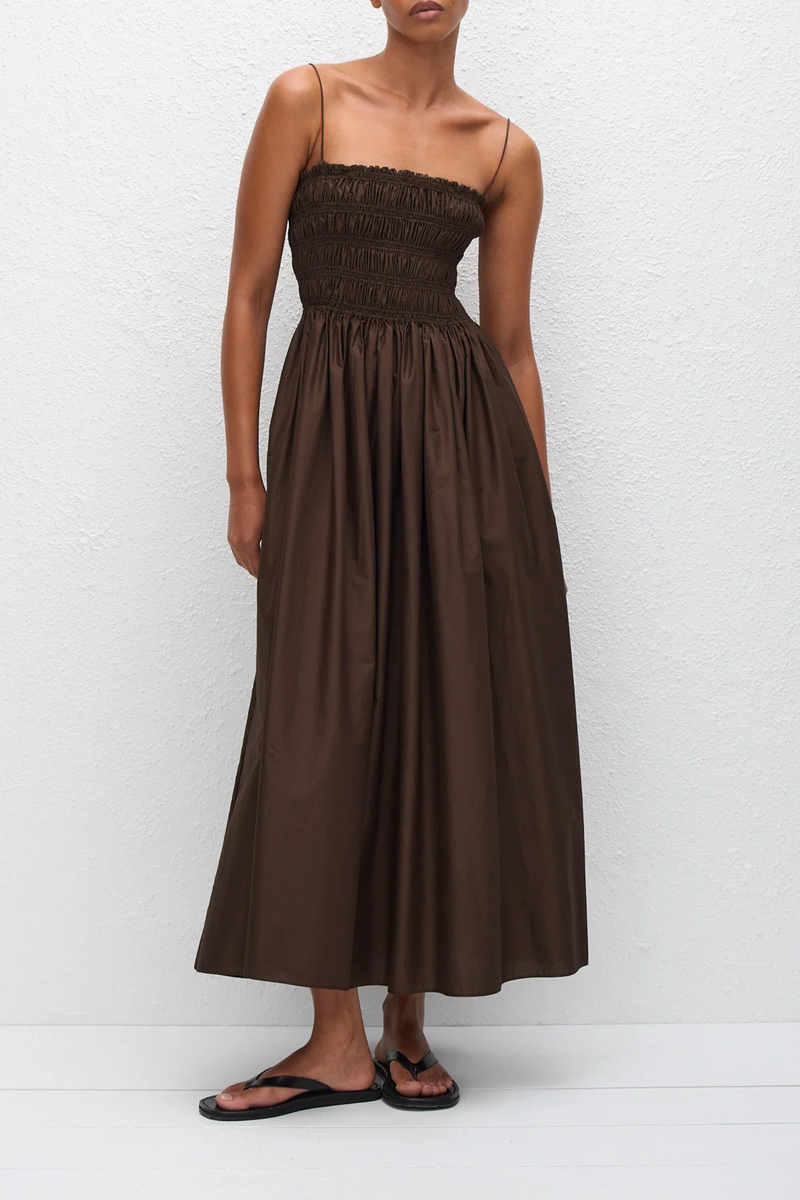front profile model wearing Shirred Bodice Midi Dress chocolate brown Pull-on dress
Cami style
Delicate shoulder straps
Repeated double elastic shirred detailing throughout the bodice
Mid-length style
Self-lined bodice
Side pockets
100% Organic Cotton Cami Dress