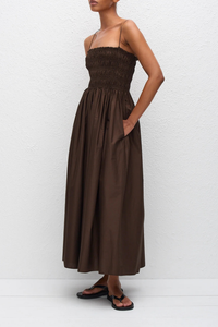 side profile model wearing Shirred Bodice Midi Dress chocolate brown Pull-on dress
Cami style
Delicate shoulder straps
Repeated double elastic shirred detailing throughout the bodice
Mid-length style
Self-lined bodice
Side pockets
100% Organic Cotton Cami Dress