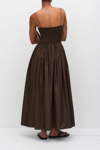 back profile model wearing Shirred Bodice Midi Dress chocolate brown Pull-on dress
Cami style
Delicate shoulder straps
Repeated double elastic shirred detailing throughout the bodice
Mid-length style
Self-lined bodice
Side pockets
100% Organic Cotton Cami Dress