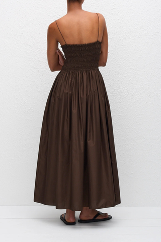 back profile model wearing Shirred Bodice Midi Dress chocolate brown Pull-on dress
Cami style
Delicate shoulder straps
Repeated double elastic shirred detailing throughout the bodice
Mid-length style
Self-lined bodice
Side pockets
100% Organic Cotton Cami Dress