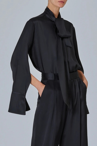 side profile model wearing  Shirt With Scarf Black Fluid blouse
Integrated neck scarf
Exaggerated cuffs
Clean hidden placket
Soft drape
57% silk 43% viscose