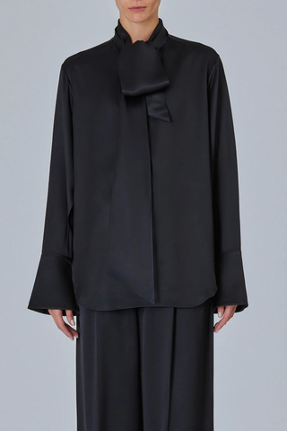 front profile model wearing  Shirt With Scarf Black Fluid blouse
Integrated neck scarf
Exaggerated cuffs
Clean hidden placket
Soft drape
57% silk 43% viscose