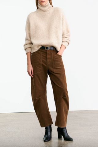 front profile model wearing Shon Corduroy Pant Caffe brown mid rise barrel leg with front utility pockets