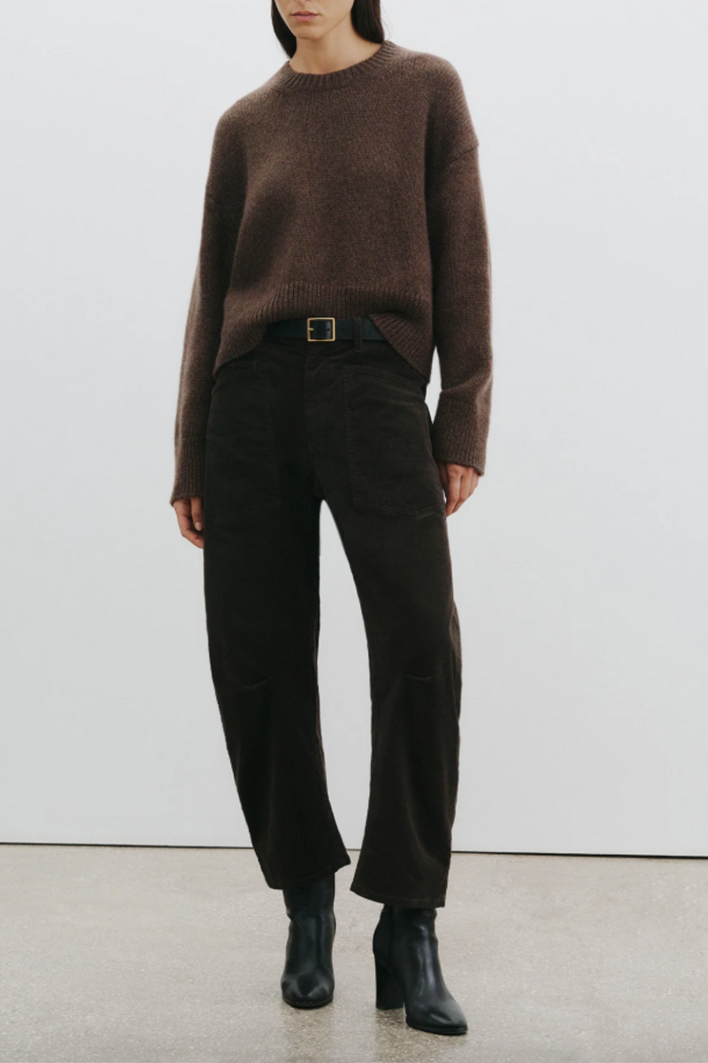 front profile model wearing Shon Corduroy Pant Chocolate brown mid rise barrel leg front utility pockets