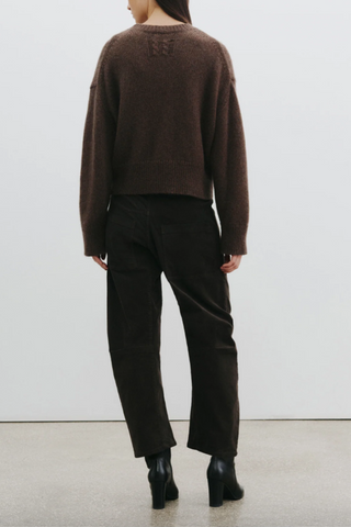 back profile model wearing Shon Corduroy Pant Chocolate brown mid rise barrel leg front utility pockets