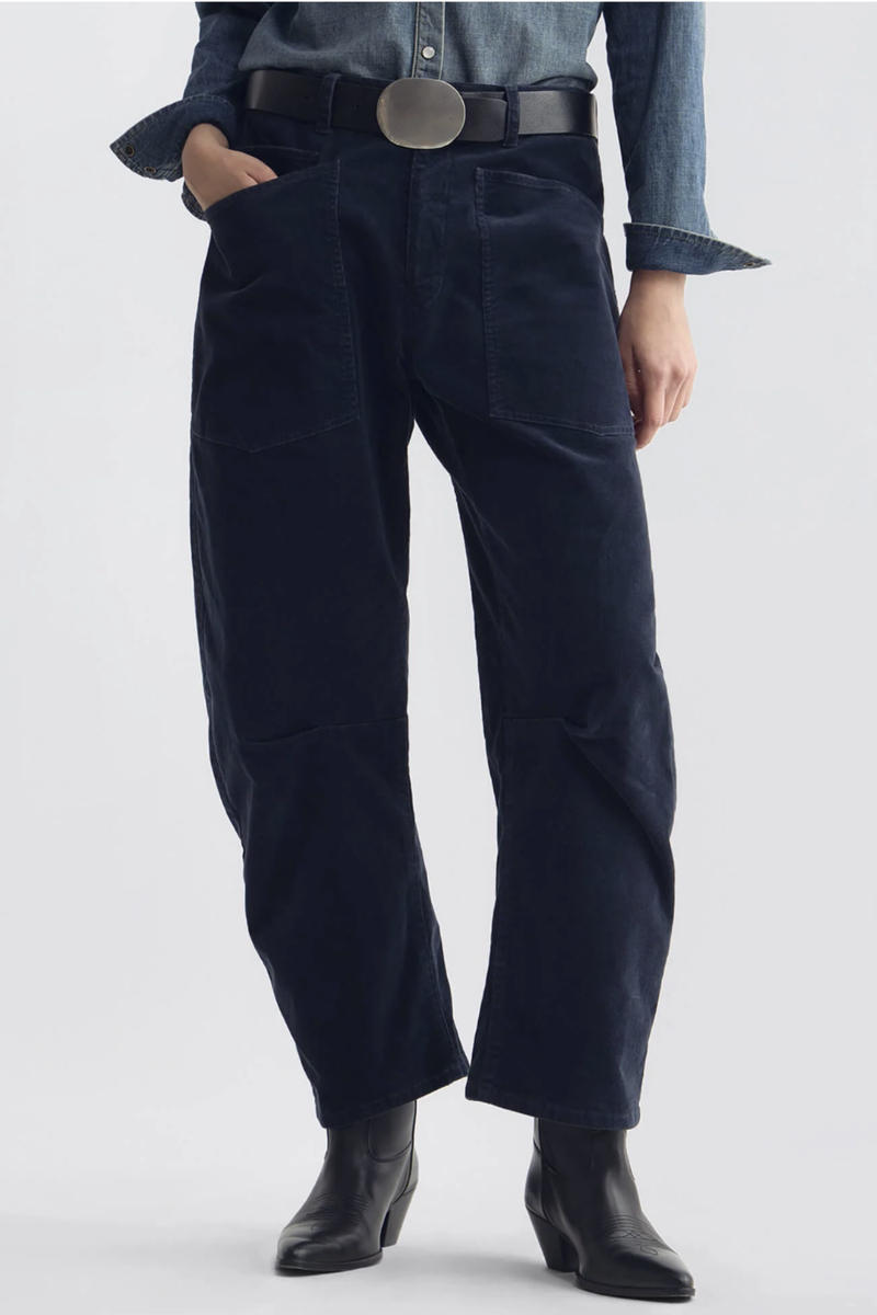 front profile model wearing Shon Corduroy Pant Service Blue Flat front
Mid-rise
Relaxed fit pant
Stretch corduroy
Curved silhouette
Easy tapered legs
Seam detail at knees
Zip fly with hidden hook and bar closure
Hidden button closure
Top-stitched front and back patch pockets
Belt loops
93% COTTON, 6% POLYESTER, 1% POLYURETHANE