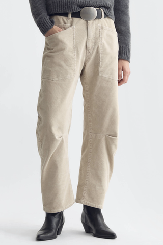 front profile model wearing  Shon Corduroy Pant Travertine cream Flat front
Mid-rise
Relaxed fit pant
Stretch corduroy
Curved silhouette
Easy tapered legs
Seam detail at knees
Zip fly with hidden hook and bar closure
Hidden button closure
Top-stitched front and back patch pockets
Belt loops
93% COTTON, 6% POLYESTER, 1% POLYURETHANE
