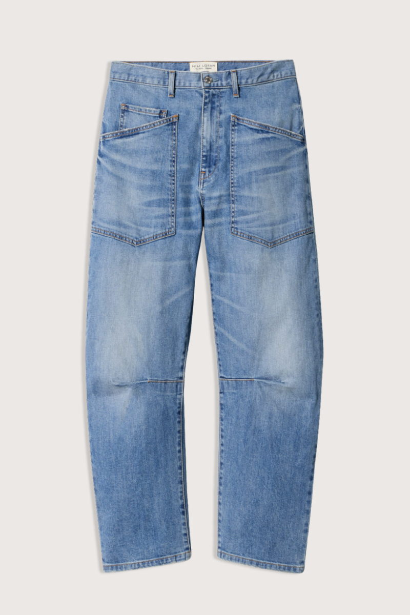 flat lay Shon Jeans Cienna Wash mid blue wash Mid-rise
Relaxed fit
Barrel leg jean
Uniquely curved silhouette
Seam detail at knees
Gusset at inseam
Zip fly
Shank closure
Top-stitched front and back patch pockets
Belt loops
100% Cotton