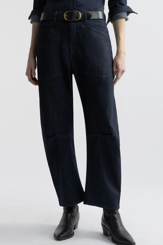front profile model wearing Shon Jeans Indigo Rinse cotton Mid-rise
Relaxed fit
Barrel leg jean
Uniquely curved silhouette
Seam detail at knees
Gusset at inseam
Zip fly
Shank closure
Top-stitched front and back patch pockets
Belt loops