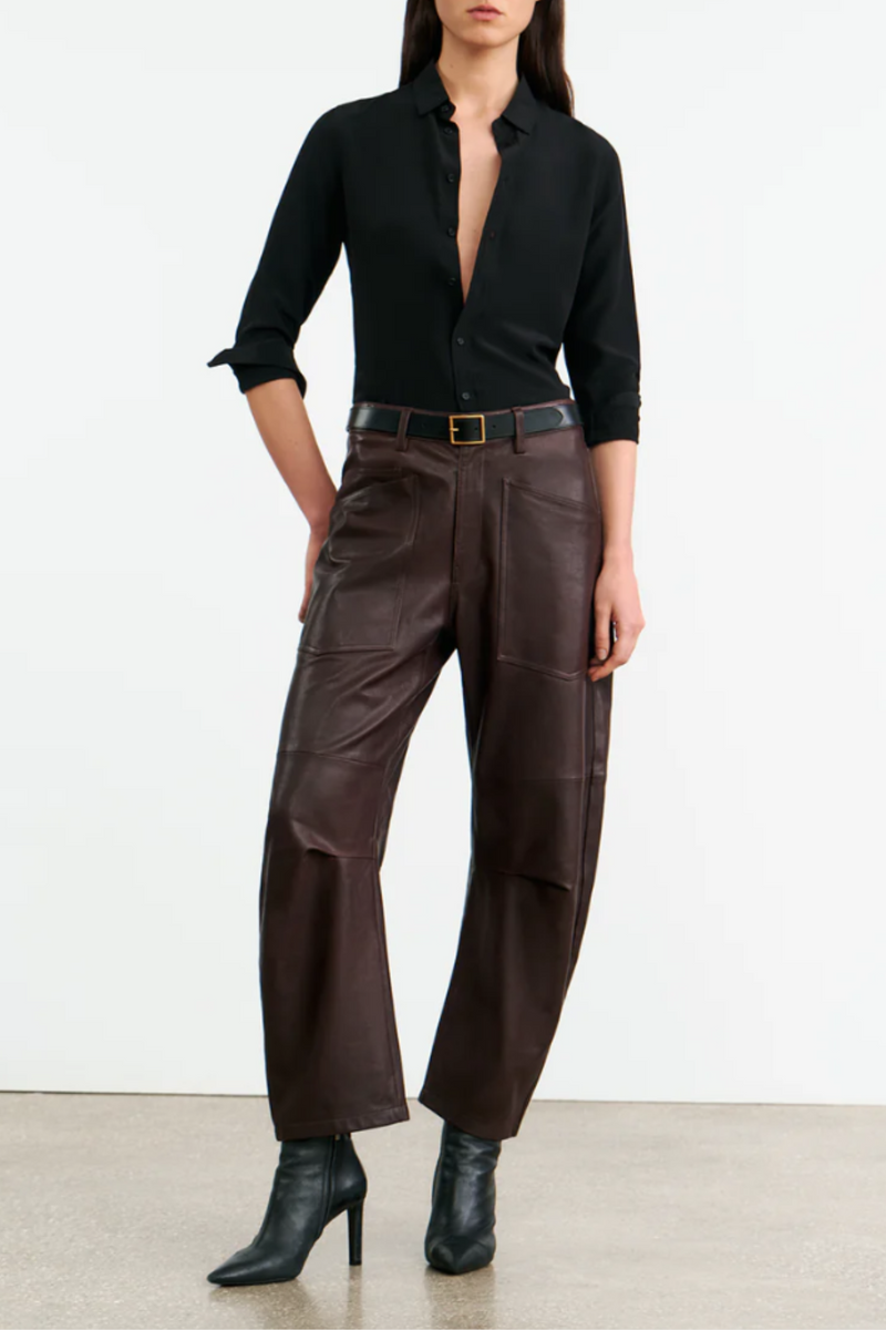 front profile model wearing Shon Leather Pant Dark Brown barrel leg front  and back utility pockets