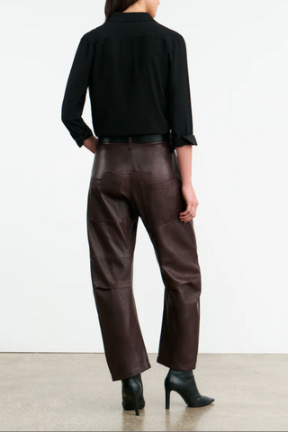 back profile model wearing Shon Leather Pant Dark Brown barrel leg front  and back utility pockets