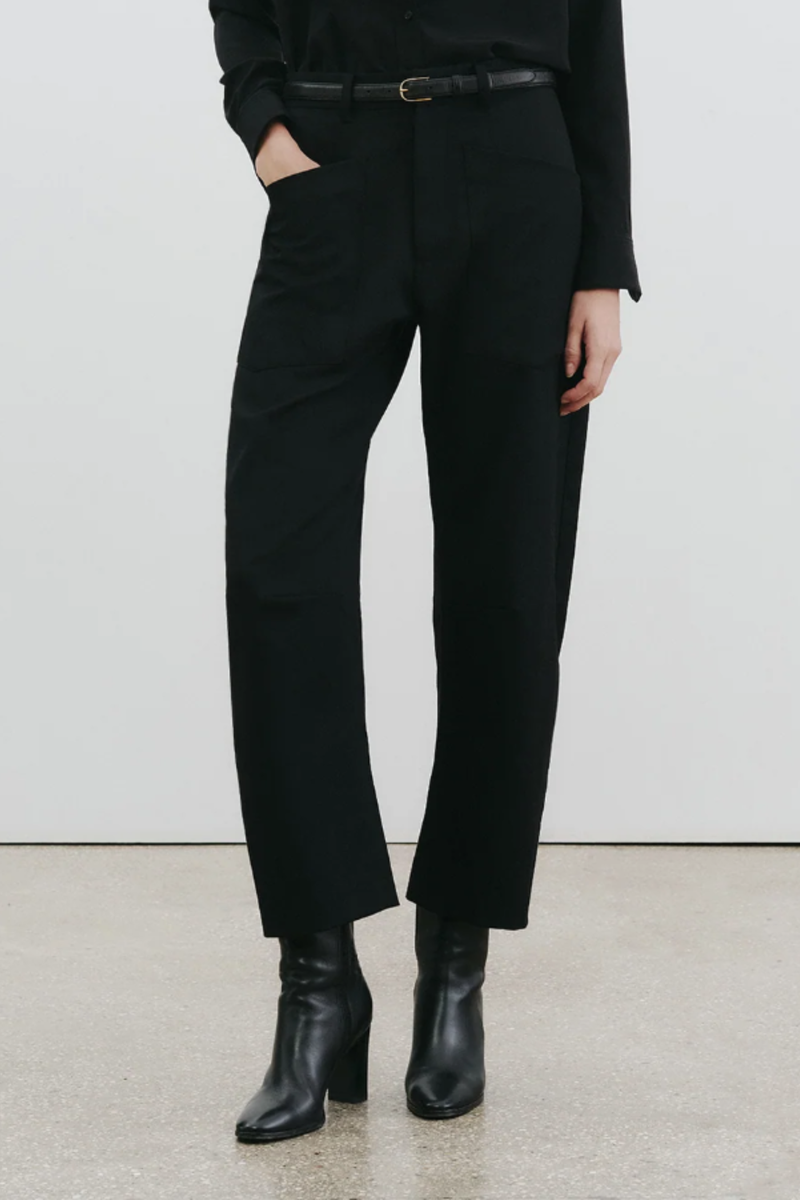 front profile model wearing Shon Wool Gaberdine Pant black Mid-rise
Relaxed fit barrel leg pant
Uniquely curved silhouette utility front pockets