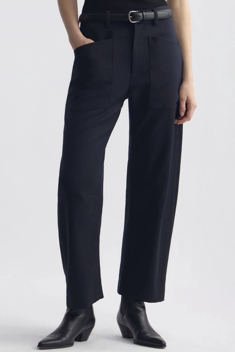 front profile model wearing  Shon Wool Gaberdine Pant Midnight navy wool Mid-rise
Relaxed fit barrel leg pant
Uniquely curved silhouette
Seam detail at knees
Gusset at inseam