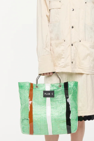 model wearing Shopping Bag - Green Green striped technical tote
Metallic handles black logo patch on the front