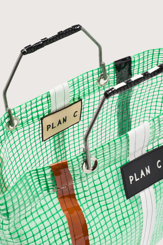 close up detail of Shopping Bag - Green Green striped technical tote
Metallic handles black logo patch on the front