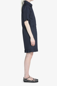 side profile model wearing Short Sleeve Poplin Dress Blue navy cotton Navy blue shirt dress
Classic collar
Short sleeves
Button-up front
Shirtdress style
Elastic waistband
Hem is finished with a ruffle
Above-the-knee length