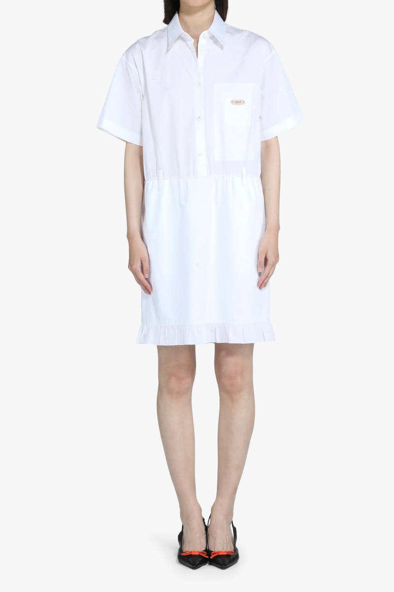 front profile model wearing Short Sleeve Poplin Dress White  cotton White shirt dress
Classic collar
Short sleeves
Button-up front
Shirtdress style
Elastic waistband
Hem is finished with a ruffle
Above-the-knee length