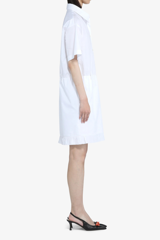 side profile model wearing Short Sleeve Poplin Dress White  cotton White shirt dress
Classic collar
Short sleeves
Button-up front
Shirtdress style
Elastic waistband
Hem is finished with a ruffle
Above-the-knee length