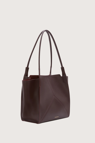 side profile Small Victoria Soft Calf Leather Tote burgundy Tonal suede lining
Unstructured silhouette
Minimal hardware
Discreetly decorative V-stitched panels