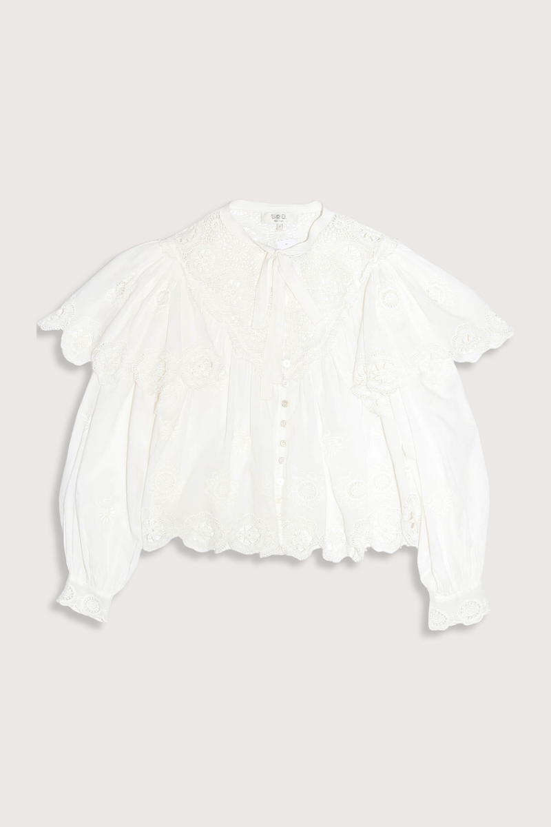 flat lay Sofia Top cream Embroidered long sleeve
Long puff sleeves
Scalloped hem
Tie at the neckline
Self-100% cotton
Embroidery-100% polyester
Button front