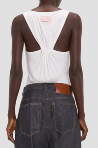 back profile model wearing Split Tank Top White cotton linen Vest top
Rounded square neckline
Cut-out detail
Low hip length
Cotton blend
Sleeveless
Pleated back