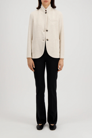 front profile model wearing Stand Collar Blazer Cream Boyfriend blazer
Unlined
Knitted hopsack
Loro Piana fabric
Stand-up collar blazer
Boxy shape
Fitted long sleeve
Patch pockets
2-button fastening plus 1 collar button for full closure