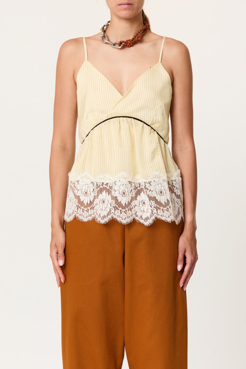 front profile model wearing  Striped Cami With Lace egg yellow Striped cupro top
V-neckline
Contrast empire waist piping
Deep scalloped lace hem
