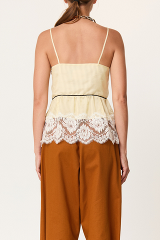 back profile model wearing  Striped Cami With Lace egg yellow Striped cupro top
V-neckline
Contrast empire waist piping
Deep scalloped lace hem