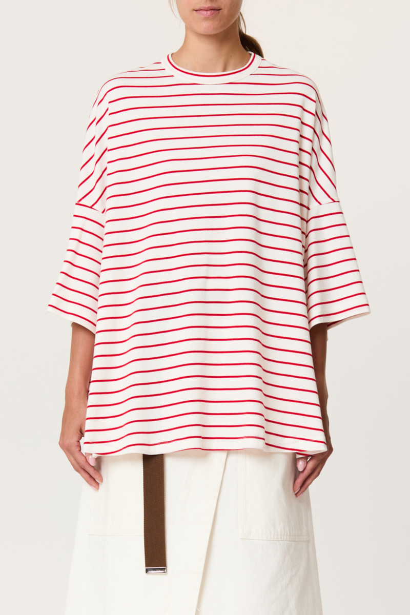 front profile model wearing  Striped Oversized Tee red white stripe White/Red wide sleeved t-shirt
Red heat-sealed Bianca patch on the back
Loose fit
100% cotton