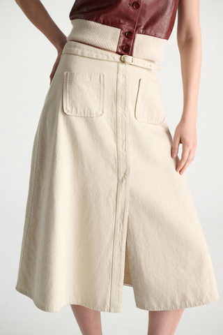 close up front profile model wearing Summer Of Love Skirt champagne white Flared skirt
Matching belt, with a signature buckle closure
85 % Cotton, 15 % Linen
Belted waist
Center front slit
Faux front button placket
Patch pockets
In-seam side zip closure
Unlined