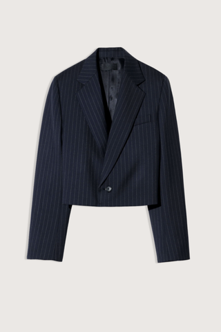 flat lay Swan Jacket midnight blue wool Boxy, cropped silhouette
Structured shoulder pads
Single-breasted
Fully lined
Internal chest pocket
Buttons at cuffs
Undercollar felt detail at back