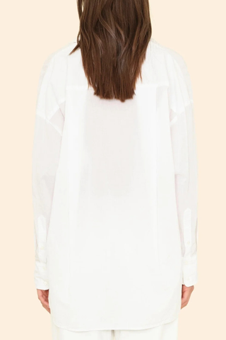 back profile model wearing Sydney Boxy Cotton Shirt White cotton poplin long sleeve Oversized button-down shirt with a left chest patch pocket