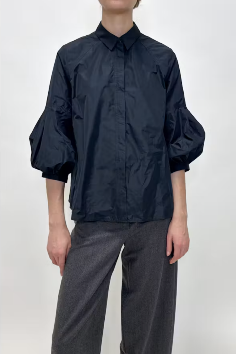 front profile model wearing Taffeta Short Sleeve Blouse Navy 100% Polyester
Classic collar
3/4 bubble sleeve
Hidden front button closure except for top button