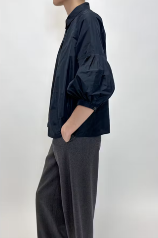 side profile model wearing Taffeta Short Sleeve Blouse Navy 100% Polyester
Classic collar
3/4 bubble sleeve
Hidden front button closure except for top button