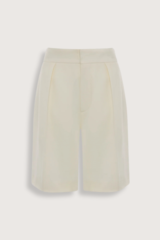 flat lay Tailored Fluid Twill Short ivory Recycled fluid wool fabrication
Knee length
Elasticated back waistband
Zip fly with hook &amp; bar closure
Front pleats
Side pockets
Back jet pockets